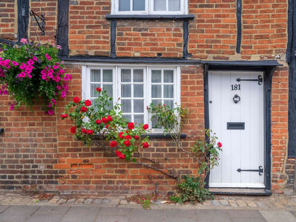 cottage di mattoni con rose rosse